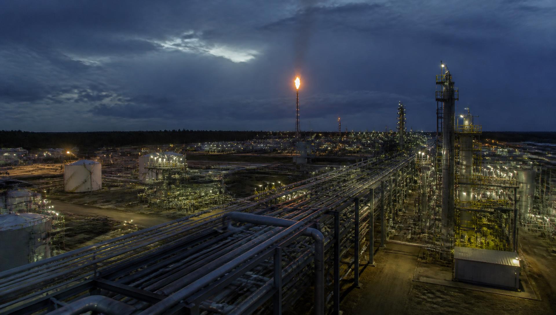 Onshore oil and gas processing facility at dusk